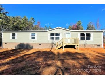 Charming one-story home featuring light siding, a wood deck and brick foundation at 3357 34Th Avenue Ne Ct, Hickory, NC 28601