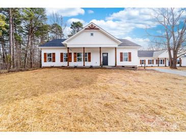 Charming single-story home with white siding, dark shutters, and a welcoming front porch at 1300 Eddie St, Gastonia, NC 28054