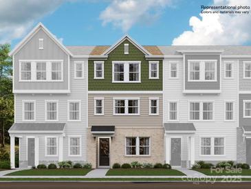 Three-story townhome with green and beige exterior at 4068 Skyboat Cir, Fort Mill, SC 29715