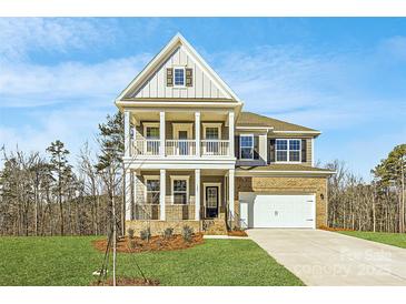 Two-story house with gray siding, white trim, and a two-car garage at 123 Dogwood Grove Pl, Troutman, NC 28166