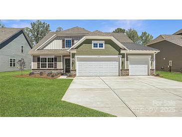 Charming craftsman-style home with a three-car garage and a beautifully landscaped front yard at 1578 Croydon St, Indian Land, SC 29707