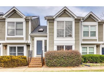 Charming two-story townhome with a brick entryway and well-maintained landscaping, creating a welcoming curb appeal at 8218 Legare Ct, Charlotte, NC 28210