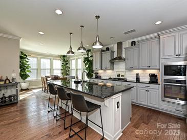 Spacious kitchen with granite island, stainless steel appliances, and hardwood floors at 946 Emory Ln, Fort Mill, SC 29708