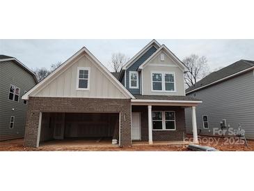 Two-story home with gray and beige exterior, attached garage, and front porch at 159 Ella Claire Dr # 008, York, SC 29745