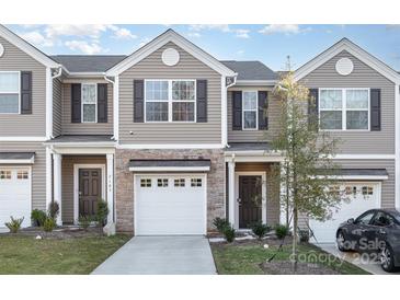 Modern 2-story townhome with attached garage and landscaped front yard at 7109 N Mills Rd, Charlotte, NC 28216