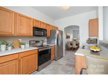 Modern kitchen with stainless steel appliances and light oak cabinets at 18107 Amberwood Glen Dr, Cornelius, NC 28031