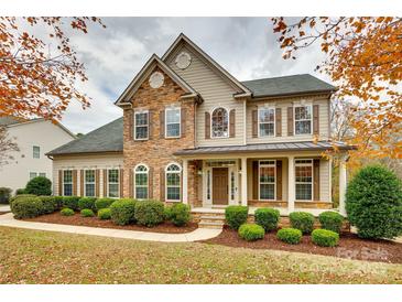 Charming two-story home with a stone and siding facade, complemented by manicured landscaping at 373 Fischer Rd, Fort Mill, SC 29715