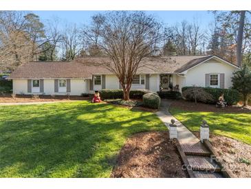 Charming one-story home with manicured lawn, brick pathway, and mature trees at 946 Scotch Dr, Gastonia, NC 28054