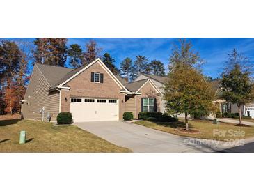 Exterior view of charming craftsman style home with attached garage and manicured lawn at 2353 Abundance Ln, Waxhaw, NC 28173