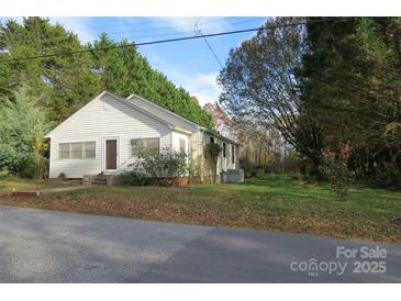 Quaint single-story home featuring white siding, mature trees and an easy to maintain front yard at 155 6Th Sw St, Taylorsville, NC 28681