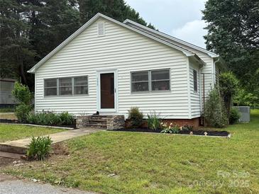 Inviting home with manicured lawn, landscaped garden beds, and a quaint front entrance at 155 6Th Sw St, Taylorsville, NC 28681