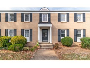 Brick building with a classic design, landscaping, and a welcoming entrance at 405 Wakefield Dr # B, Charlotte, NC 28209