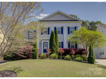 Charming two-story home with a well-manicured lawn and colorful landscaping, inviting curb appeal at 10029 Daufuskie Dr, Charlotte, NC 28278