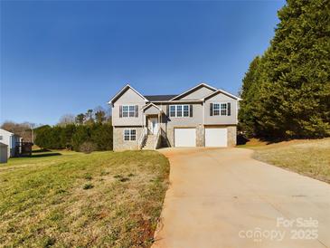 Two-story house with gray siding, stone accents, and a two-car garage at 2061 Gary Ln, Hickory, NC 28602