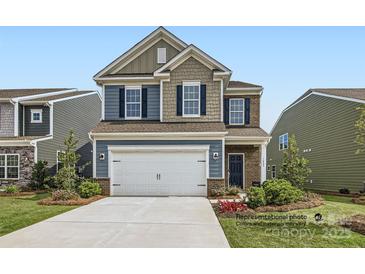 Two-story home with a two-car garage and landscaped lawn at 1812 Otter Perch Ln, Fort Mill, SC 29715