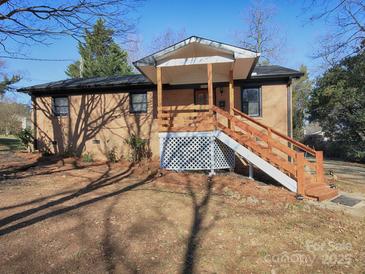 Brick ranch house with a wooden deck and stairs at 5315 Ruth Dr, Charlotte, NC 28215