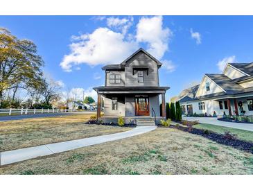 Charming two-story home featuring gray siding, covered porch, and walkway at 901 Edgemont Ave, Belmont, NC 28012