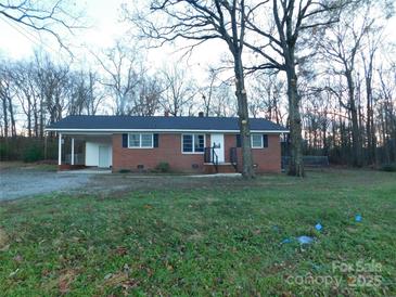 Charming single-story brick home with an attached carport and black shutters at 8600 E Highway 74 E Hwy, Marshville, NC 28103