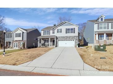 Two-story house with gray siding, stone accents, and a two-car garage at 244 Court House Ave, York, SC 29745