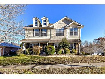 Two-story house with landscaped yard and brick accents at 7534 April Mist Trl, Huntersville, NC 28078