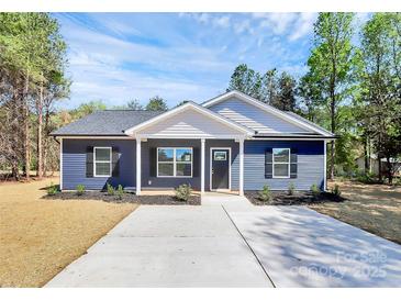 Charming single-story home with blue siding and a well-manicured front yard, enhanced by black shutters at 872 Old Mocksville Rd # 1, Statesville, NC 28625