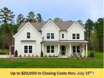 Beautiful white two-story home with black trim, lush lawn, and inviting front porch at 1875 Rock Hill Church Rd # 4, Matthews, NC 28104