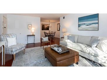 Bright living room with hardwood floors, comfy seating, and access to a patio at 4754 Hedgemore Dr # S, Charlotte, NC 28209