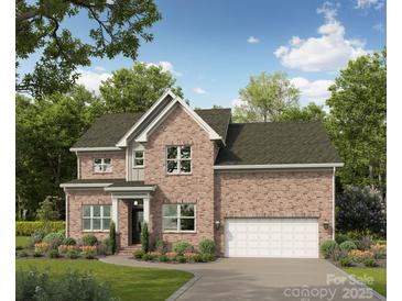 Two-story brick home with landscaped yard and attached garage at 10619 Newberry Park Ln, Charlotte, NC 28277