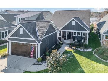 Gray house with a brown garage and American flag at 112 Sisters Cove Ct, Mooresville, NC 28117