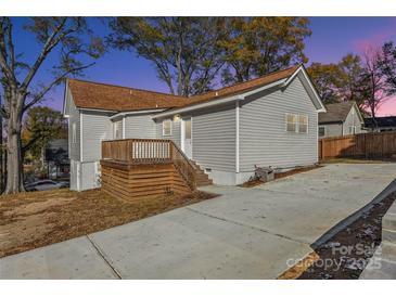 Charming home with a gray exterior, wooden deck, and a long driveway at 287 Young Sw Ave, Concord, NC 28025