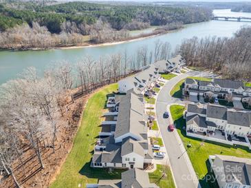 Beautiful aerial view of the townhomes along the river and natural landscape at 833 River Park Rd, Belmont, NC 28012