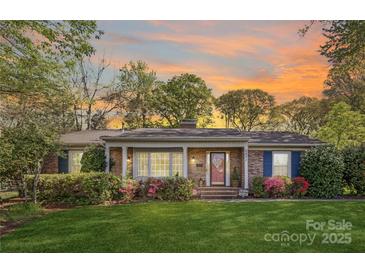 Charming brick home with well-manicured lawn and colorful landscaping, creating inviting curb appeal at 5431 Park Rd, Charlotte, NC 28209