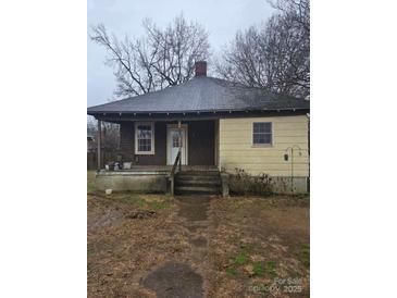 Quaint single Gathering home with covered front porch and compact yard needs some tender loving care at 50 Ranlo Ave, Gastonia, NC 28054