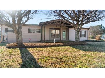 Ranch style home with covered porch and mature trees in front yard at 202 Mountain View Dr, Taylorsville, NC 28681