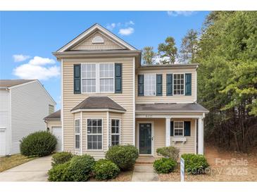 Charming two-story home with a well-manicured lawn and inviting front porch at 8633 Sawleaf Ct, Charlotte, NC 28215