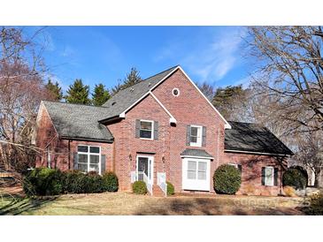 Charming two-story brick home with a well-manicured lawn and beautiful landscaping at 104 Woodvale Cir, Lincolnton, NC 28092