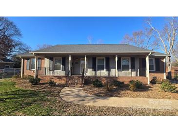 Charming home featuring a covered front porch and a well-maintained landscaped yard with a walkway at 1308 Princeton Ave, Gastonia, NC 28054