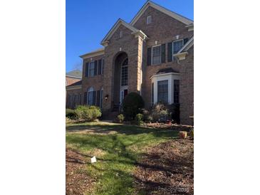 Brick two-story house with a large front yard and landscaping at 5503 Piper Glen Dr, Charlotte, NC 28277