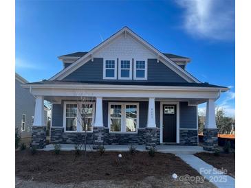 Craftsman style home with gray siding, stone accents, and a front porch at 9605 Pointer Rd # 78, Huntersville, NC 28078