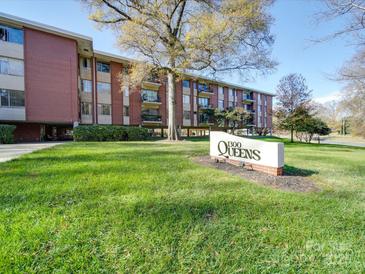 Beautiful brick apartment building with a well-manicured lawn and professional signage at 1300 Queens Rd # 303, Charlotte, NC 28207