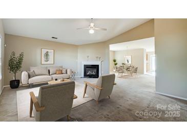 Spacious living room features a fireplace and an open floor plan at 9315 Ames Hollow Rd, Charlotte, NC 28216