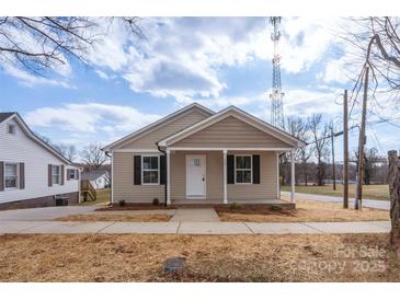 Tan house with white trim and a covered porch at 17 N Arlington St, Salisbury, NC 28144