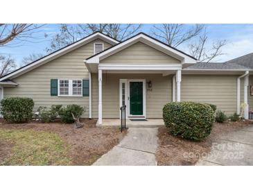 Charming home featuring an inviting entryway with a well-manicured lawn and complementary green door and shutters at 2712 New Hamlin Way, Charlotte, NC 28210