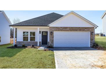 Brick and white charming ranch home with a two-car garage and landscaped lawn at 1535 Solitude Ct, Kannapolis, NC 28081