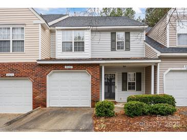 Brick front townhouse with attached garage and landscaping at 2022 University Heights Ln, Charlotte, NC 28213