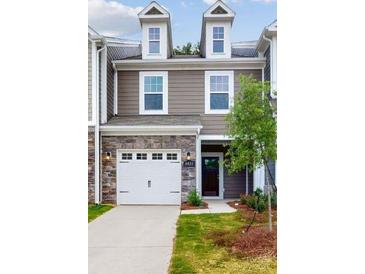 Charming two-story home features stone accents, attached garage, and welcoming entryway at 4031 Lawnview Dr, Charlotte, NC 28269