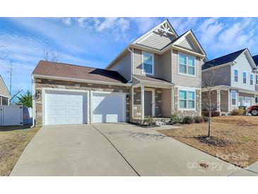 Charming two-story home with a stone and siding facade, two-car garage, and well-maintained landscaping at 980 Von Buren Blvd, Rock Hill, SC 29730