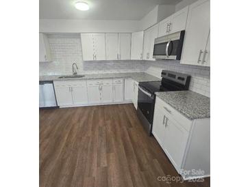 Renovated kitchen with stainless steel appliances and granite countertops at 2623 Trumpet Ct, Fort Mill, SC 29715