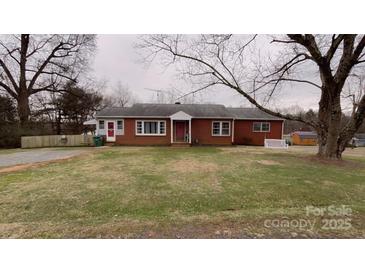 Brick ranch house with a large front yard and mature trees at 325 Hunter St, Salisbury, NC 28144