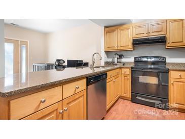 Kitchen with granite countertops and stainless steel appliances at 3706 Selwyn Farms Ln # 17-3, Charlotte, NC 28209